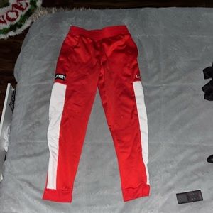 Red and white Nike pants